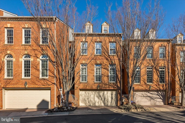 townhome / multi-family property featuring a garage