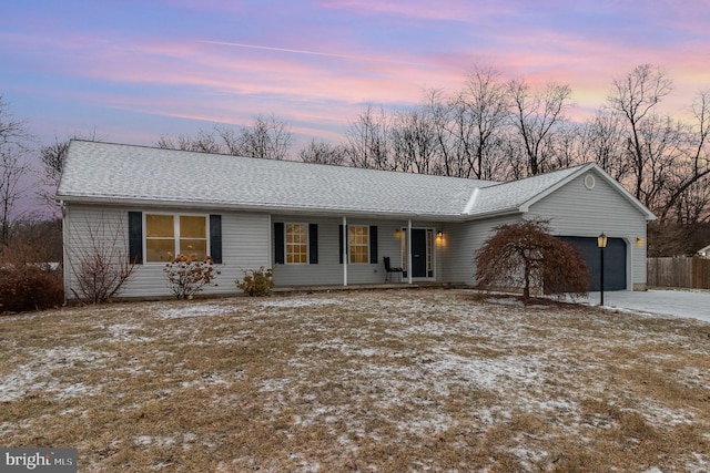 ranch-style house with a garage and covered porch