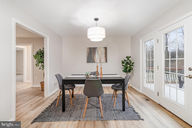 dining space featuring light wood-type flooring