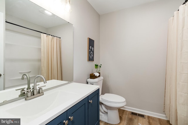 bathroom with vanity, hardwood / wood-style floors, and toilet