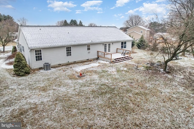 back of property with a wooden deck and central AC