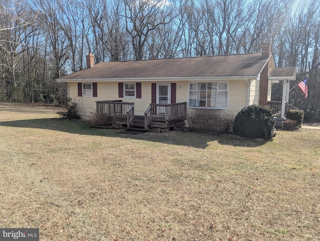 ranch-style house with a front lawn and a deck