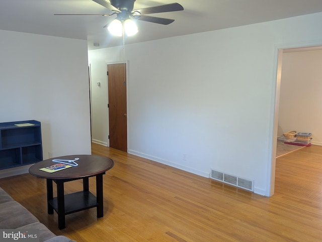 living room featuring light hardwood / wood-style floors and ceiling fan