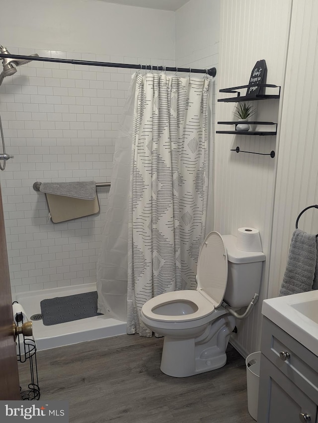 bathroom with vanity, a shower with curtain, toilet, and hardwood / wood-style flooring