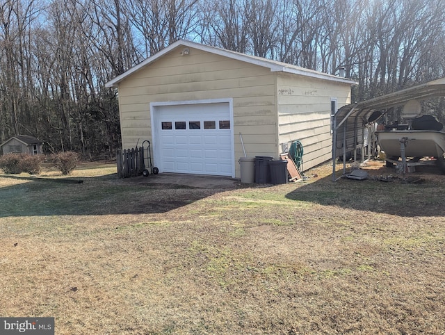 garage featuring a carport and a lawn