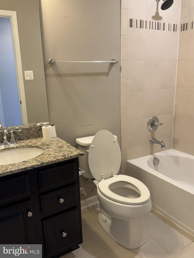 full bathroom featuring vanity, toilet, tile patterned floors, and tiled shower / bath