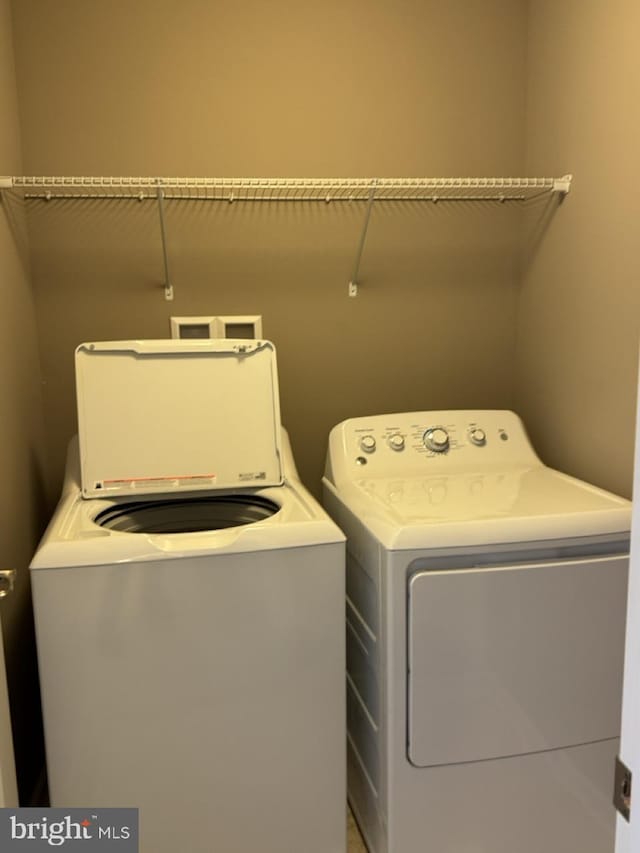 clothes washing area featuring independent washer and dryer