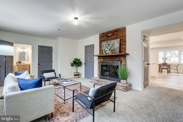 carpeted living room featuring a fireplace