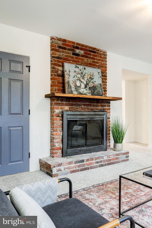 living room with carpet floors and a fireplace