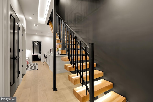 staircase with wood-type flooring