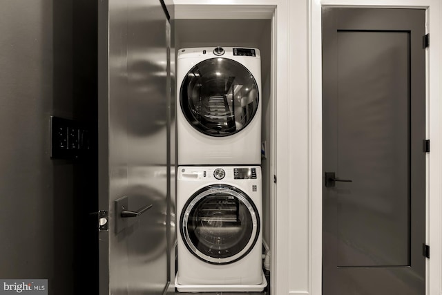 clothes washing area featuring stacked washer / drying machine