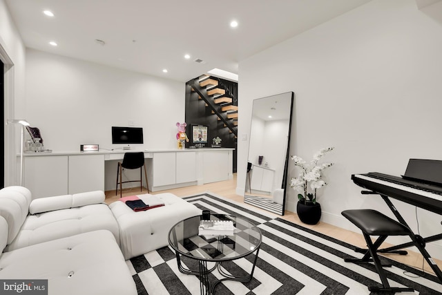 living room with light hardwood / wood-style flooring and built in desk