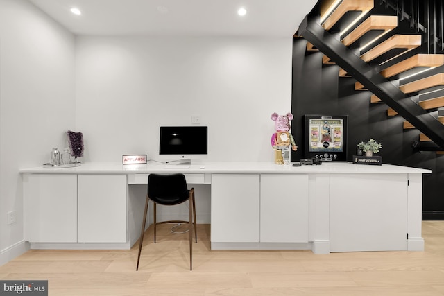 office featuring built in desk and light hardwood / wood-style flooring