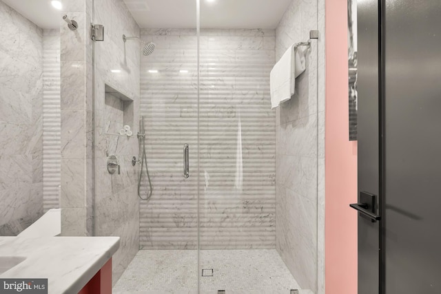 bathroom featuring vanity and an enclosed shower