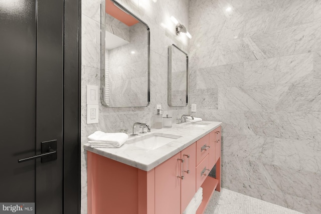 bathroom featuring vanity and tile walls