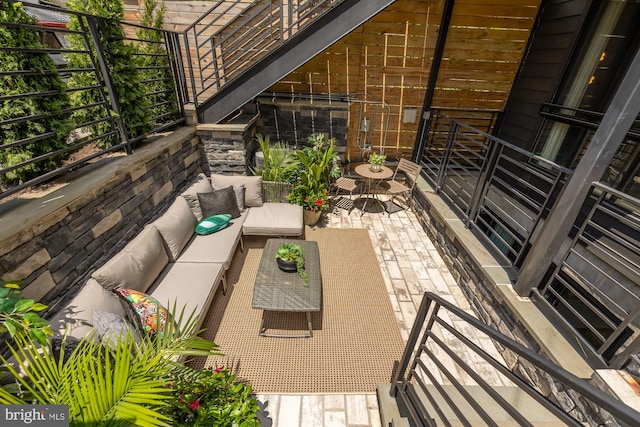 balcony with an outdoor hangout area and a patio area