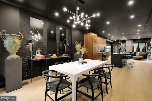 dining area featuring light hardwood / wood-style floors and a chandelier