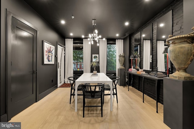 dining area featuring a notable chandelier and light wood-type flooring