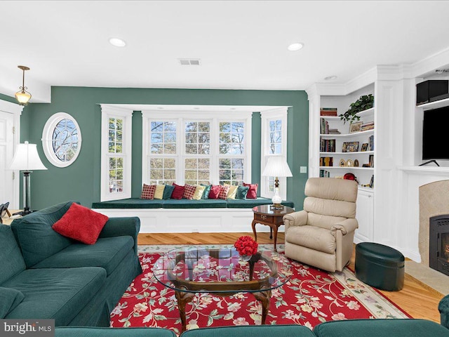 living room featuring a premium fireplace and hardwood / wood-style floors