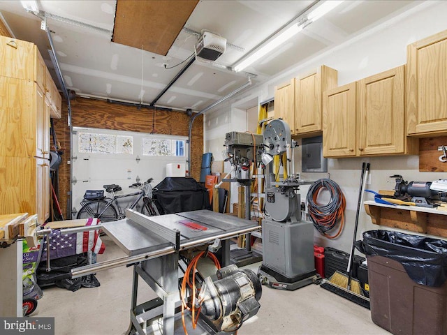 garage featuring electric panel and a garage door opener