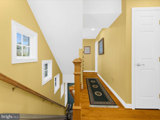 corridor with hardwood / wood-style flooring