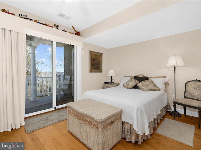 bedroom featuring ceiling fan, wood-type flooring, and access to exterior