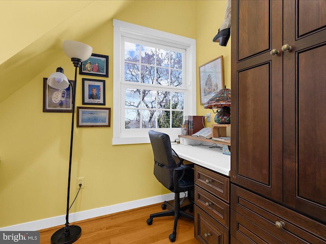 office space featuring hardwood / wood-style flooring and vaulted ceiling