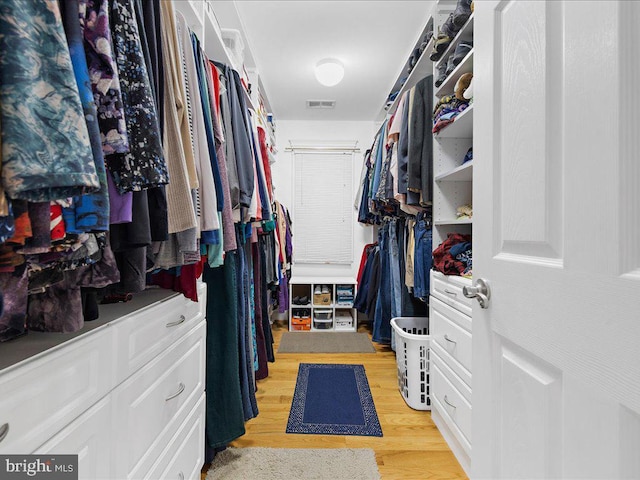 spacious closet with light hardwood / wood-style floors