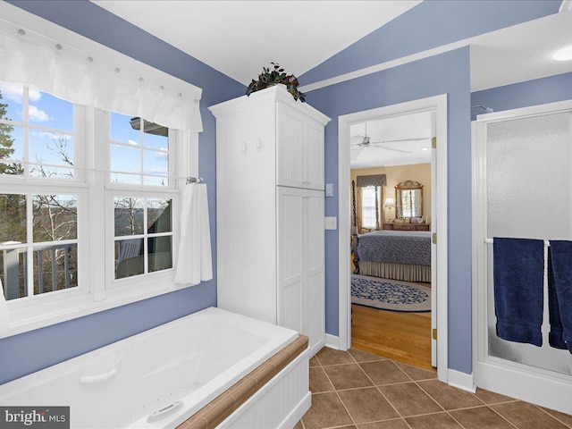 bathroom with tile patterned floors, lofted ceiling, independent shower and bath, and ceiling fan