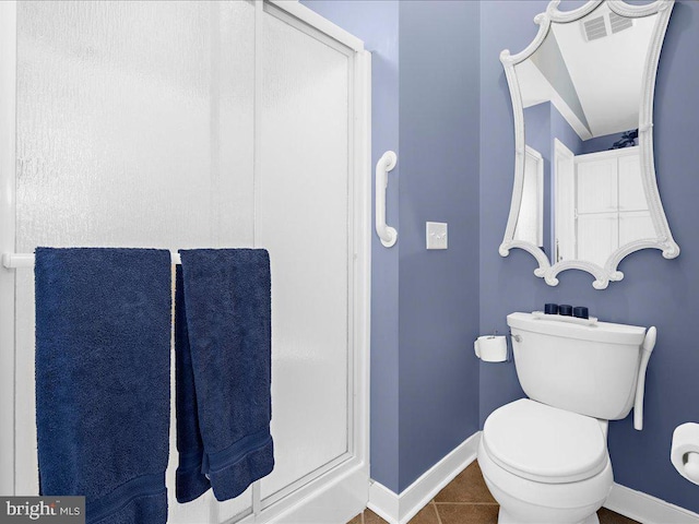 bathroom with tile patterned flooring and toilet