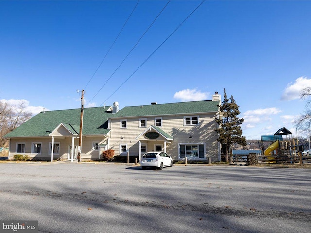 view of front of property with a playground