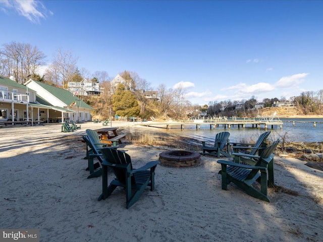 view of yard with a water view and a fire pit