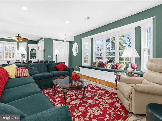 living room featuring hardwood / wood-style floors and ceiling fan