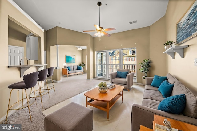 tiled living room with high vaulted ceiling and ceiling fan