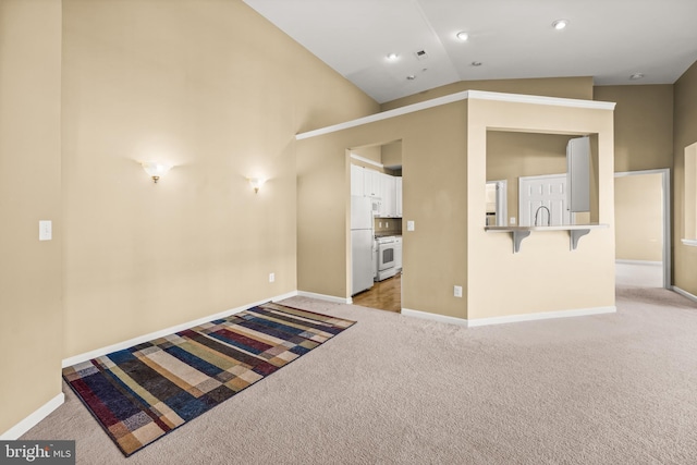 interior space with light colored carpet and vaulted ceiling