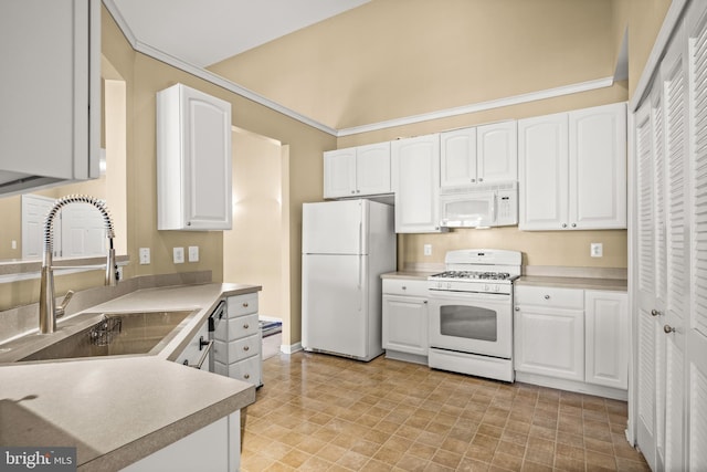 kitchen with white cabinetry, sink, white appliances, and lofted ceiling