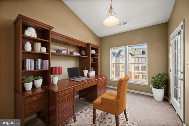 office area with vaulted ceiling and light carpet