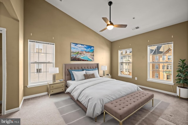 carpeted bedroom featuring high vaulted ceiling and ceiling fan