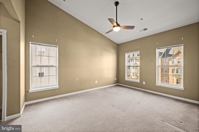 carpeted empty room featuring high vaulted ceiling and ceiling fan