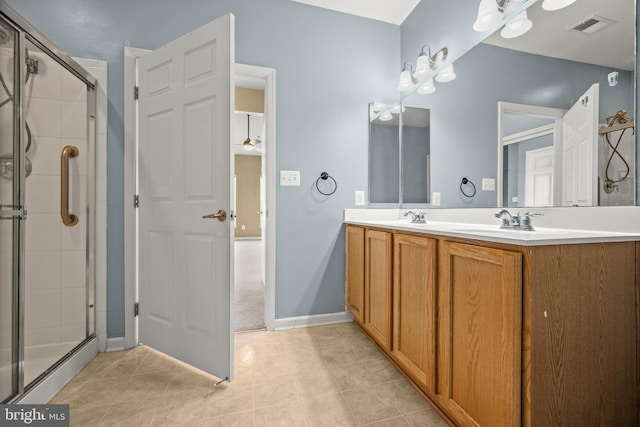 bathroom with vanity, a shower with shower door, and tile patterned flooring