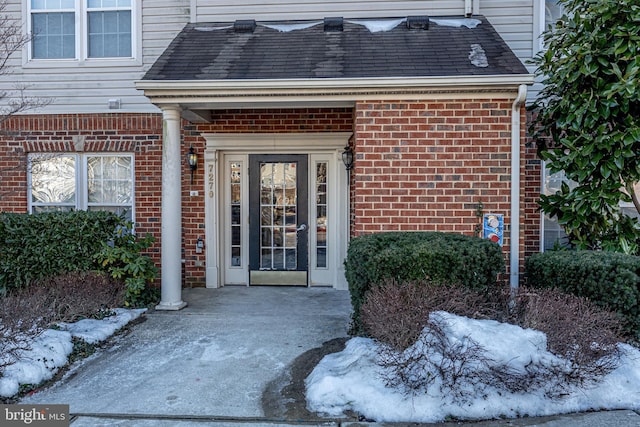 view of snow covered property entrance