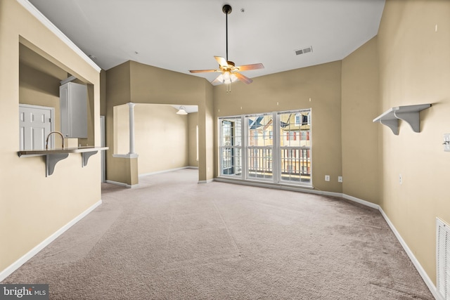 unfurnished living room featuring ceiling fan, light colored carpet, and high vaulted ceiling