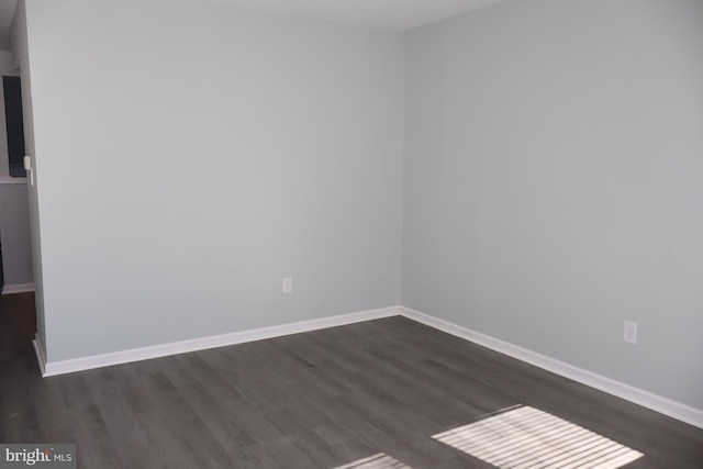 unfurnished room featuring dark hardwood / wood-style flooring