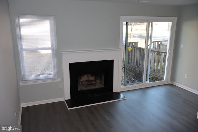 unfurnished living room featuring dark wood-type flooring