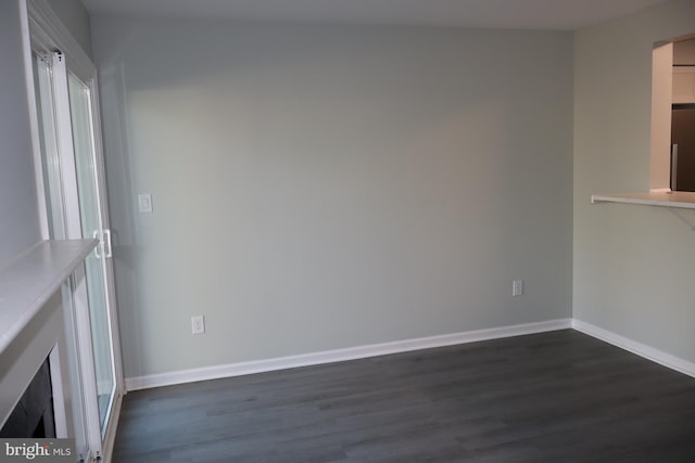 unfurnished living room featuring dark wood-type flooring