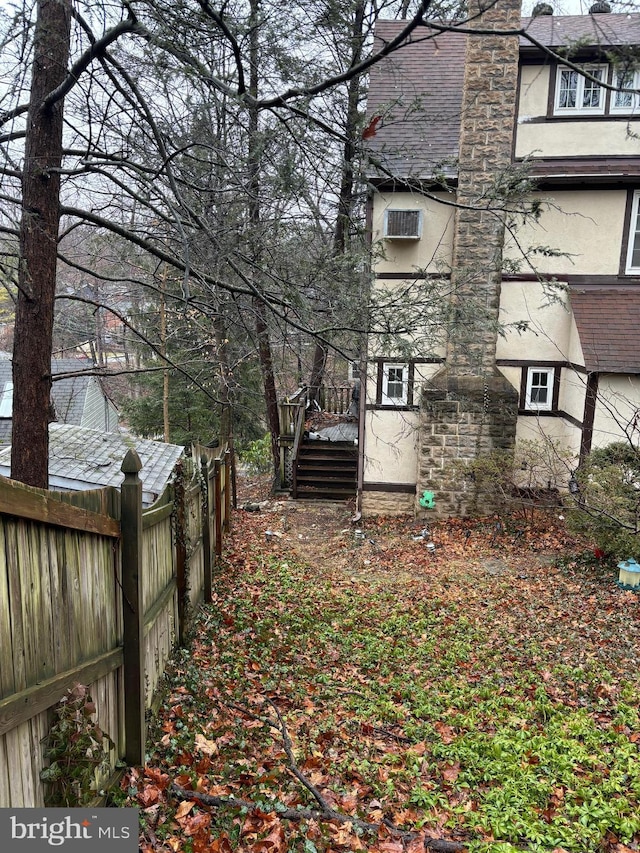 view of yard with a wall mounted air conditioner