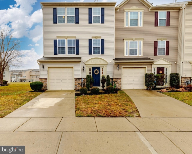 view of property featuring a garage and a front yard