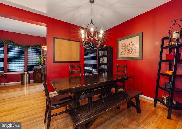 dining space with an inviting chandelier and light wood-type flooring