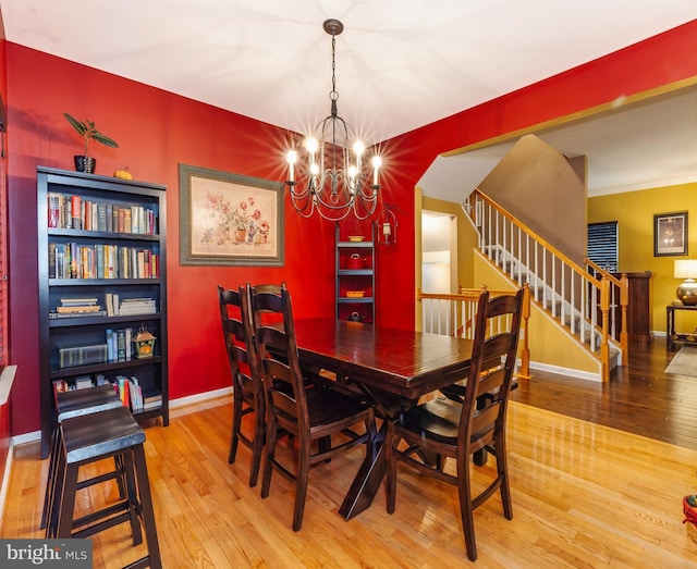 dining room featuring wood-type flooring and a chandelier