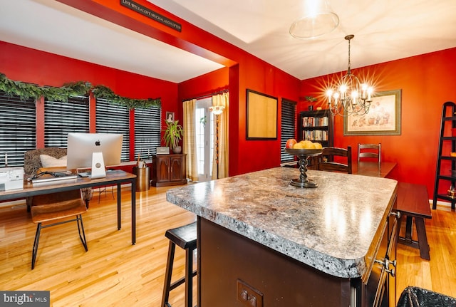 kitchen with pendant lighting, a notable chandelier, and light wood-type flooring